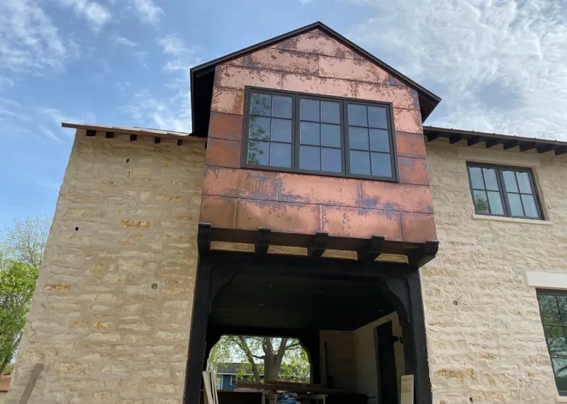 Copper metal panel facade on a stone building for Skylight Installation in San Martin